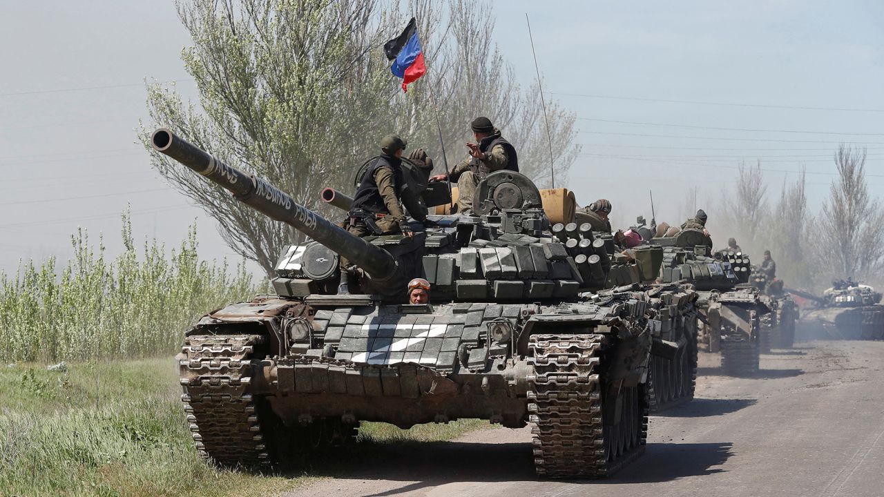 Service members of pro-Russian troops drive armored vehicles near Novoazovsk in Ukraine's eastern Donetsk region on May 6, 2022.
