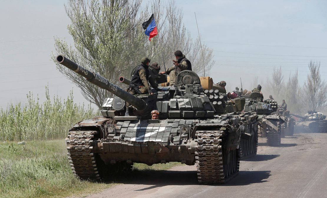 Service members of pro-Russian troops drive armored vehicles near Novoazovsk in Ukraine's eastern Donetsk region on May 6, 2022.