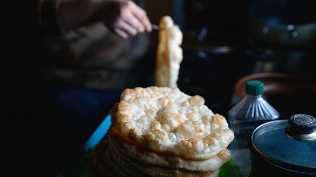 <strong>Fry bread (Native Americans in the US):</strong> A Navajo woman cooks fry bread. It's delicious, but it is also a byproduct of forced removal that has evolved into a complicated symbol for many tribes.