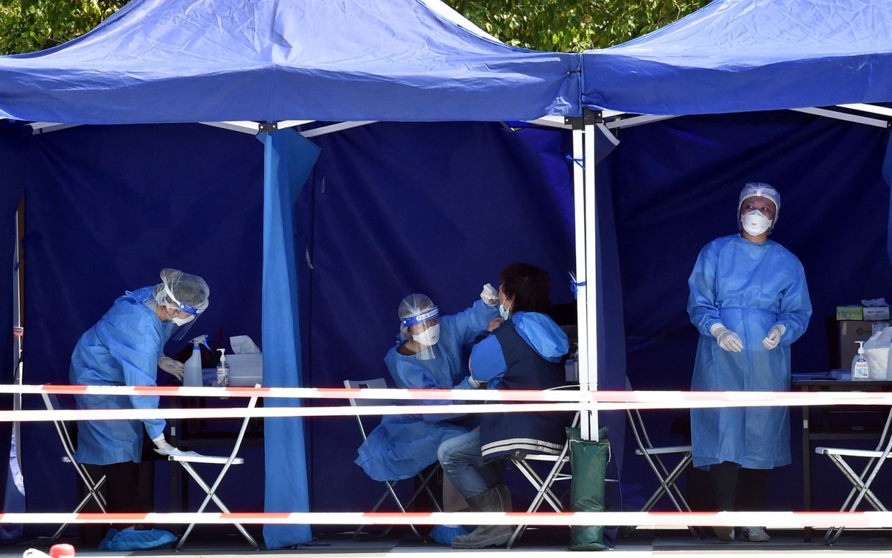 Medical workers collect PCR test swabs in Hong Kong