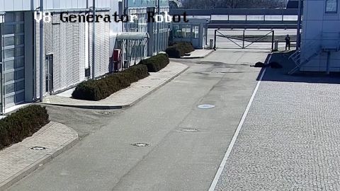 Russian soldiers, in the top right corner of this image from the video, walk away from the bodies of the men they have just killed, leaving them lying in the shadow.