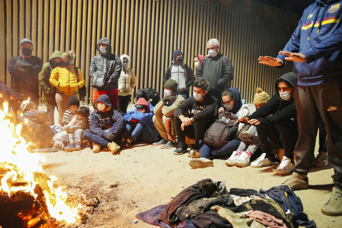 Cubans that have just crossed the US-Mexico border huddle near a fire in Yuma, Arizona in February.