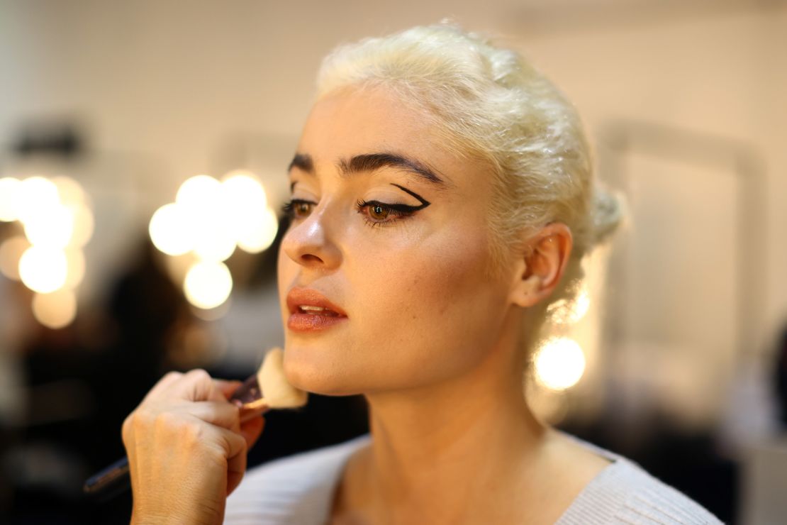 A model prepares backstage ahead of The Curve Edit show.