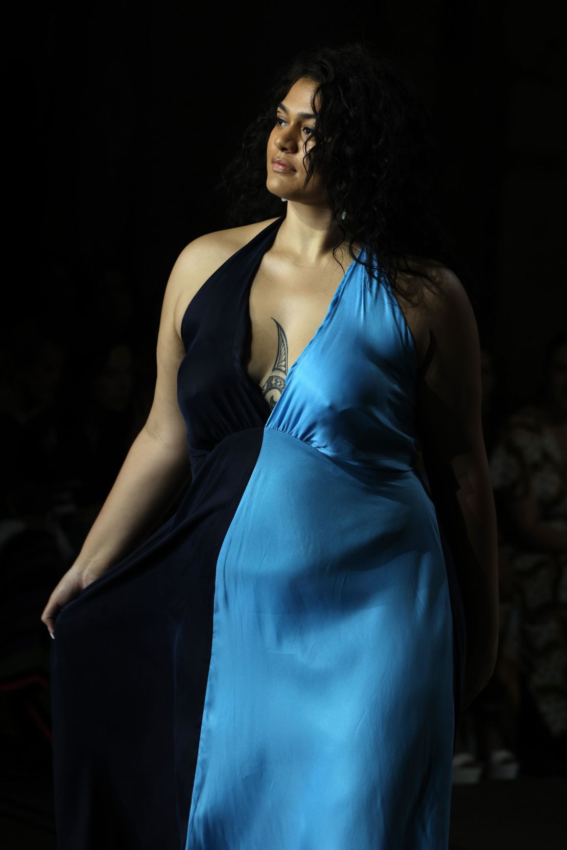 A model walks the runway in a gown by Embody Women.