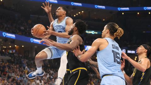 Grizzlies guard De'Anthony Melton shoots the ball over Warriors guard Andrew Wiggins.