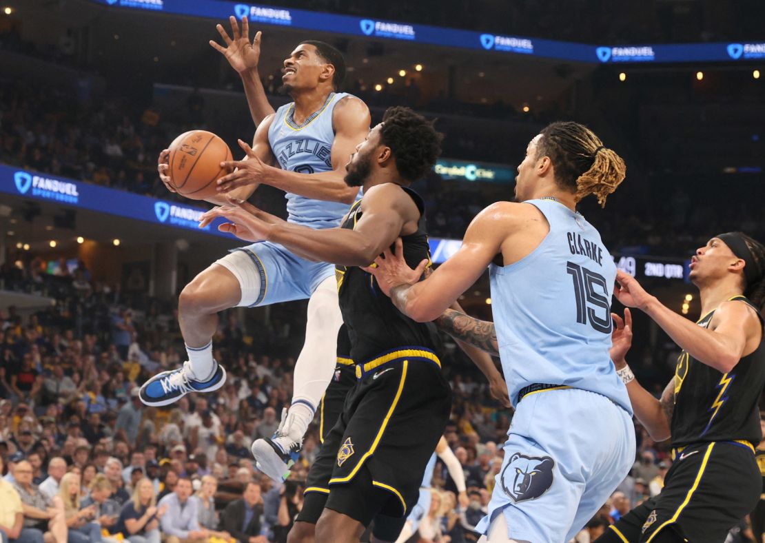 Grizzlies guard De'Anthony Melton shoots the ball over Warriors guard Andrew Wiggins.