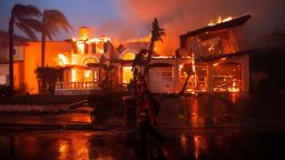 Mandatory Credit: Photo by ETIENNE LAURENT/EPA-EFE/Shutterstock (12936745l)
A firefighter walks past a house on fire caused by the Coastal Fire in Laguna Niguel, California, USA, 11 May 2022. Latest reports state that the 200 acre fire has destroyed more than a dozen homes.
Coastal Fire destroys houses in Laguna Niguel, USA - 11 May 2022