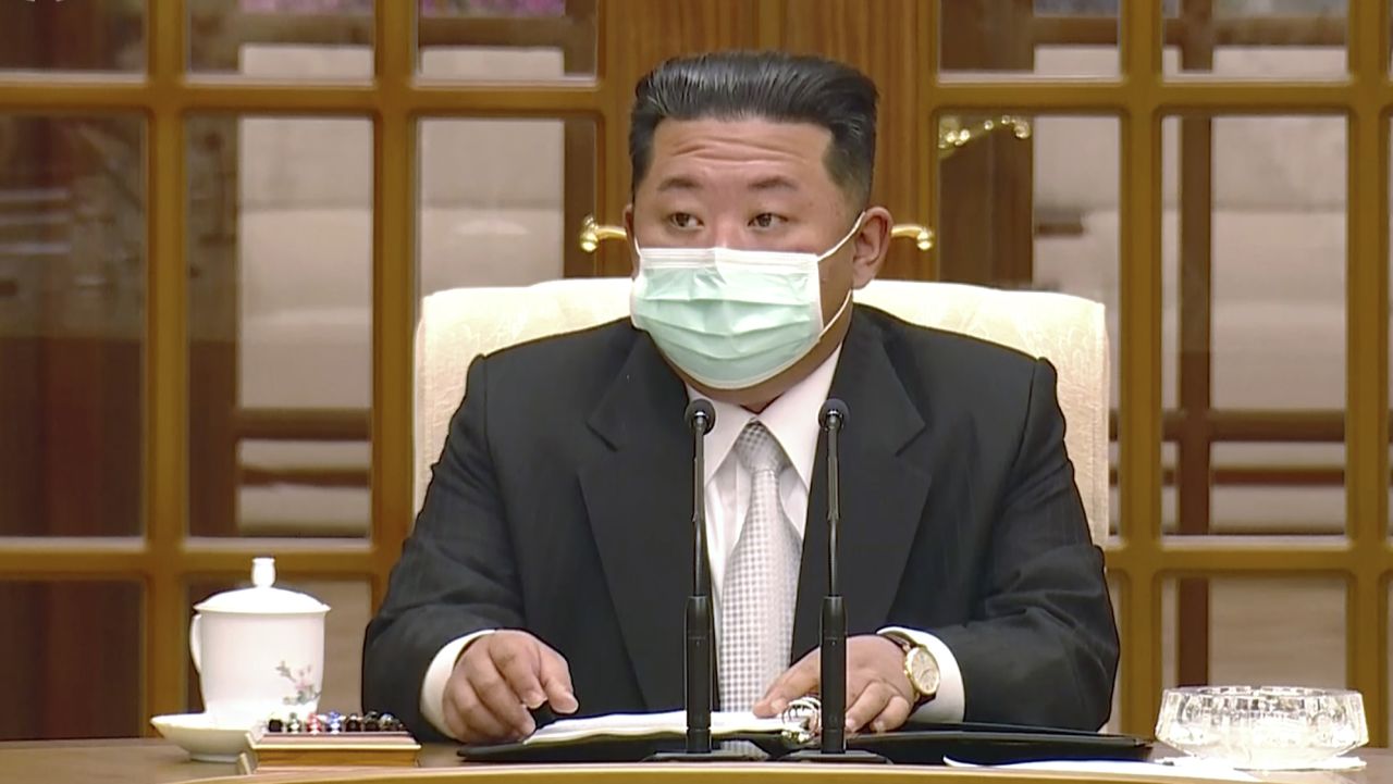 In this image made from video broadcasted by North Korea's KRT, North Korean leader Kim Jong Un wears a face mask on state television during a meeting acknowledging the country's first case of COVID-19 Thursday, May 12, 2022, in Pyongyang, North Korea. North Korea imposed a nationwide lockdown Thursday to control its first acknowledged COVID-19 outbreak after holding for more than two years to a widely doubted claim of a perfect record keeping out the virus that has spread to nearly every place in the world. (KRT via AP)