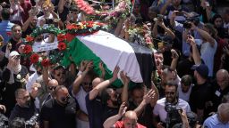 Family, friends and colleagues of slain Al Jazeera journalist Shireen Abu Akleh carry her coffin to a hospital in the East Jerusalem neighborhood of Sheikh Jarrah on May 12.