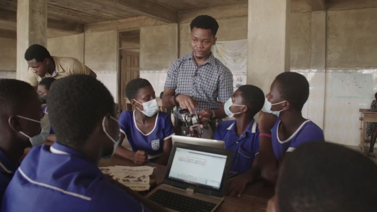 Jonathan Kennedy Sowah, founder of InovTech STEM Center, teaches students at the the Teshie Anglican School in Ghana how to program a robot. 