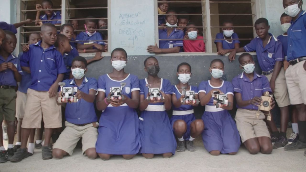Students gather outside of Teshie Anglican School in Ghana after learning how to code robots. 