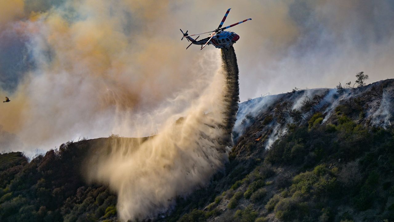 Laguna Niguel, CA - May 11: Firefighter drop water in Aliso Canyon during the Coastal Fire in Laguna Niguel, CA, on Wednesday, May 11, 2022. More than a dozen homes overlooking the ocean in Laguna Niguel were engulfed in flames as a fast-moving brush fire is spreading rapidly amid strong winds. (Photo by Jeff Gritchen/MediaNews Group/Orange County Register via Getty Images)