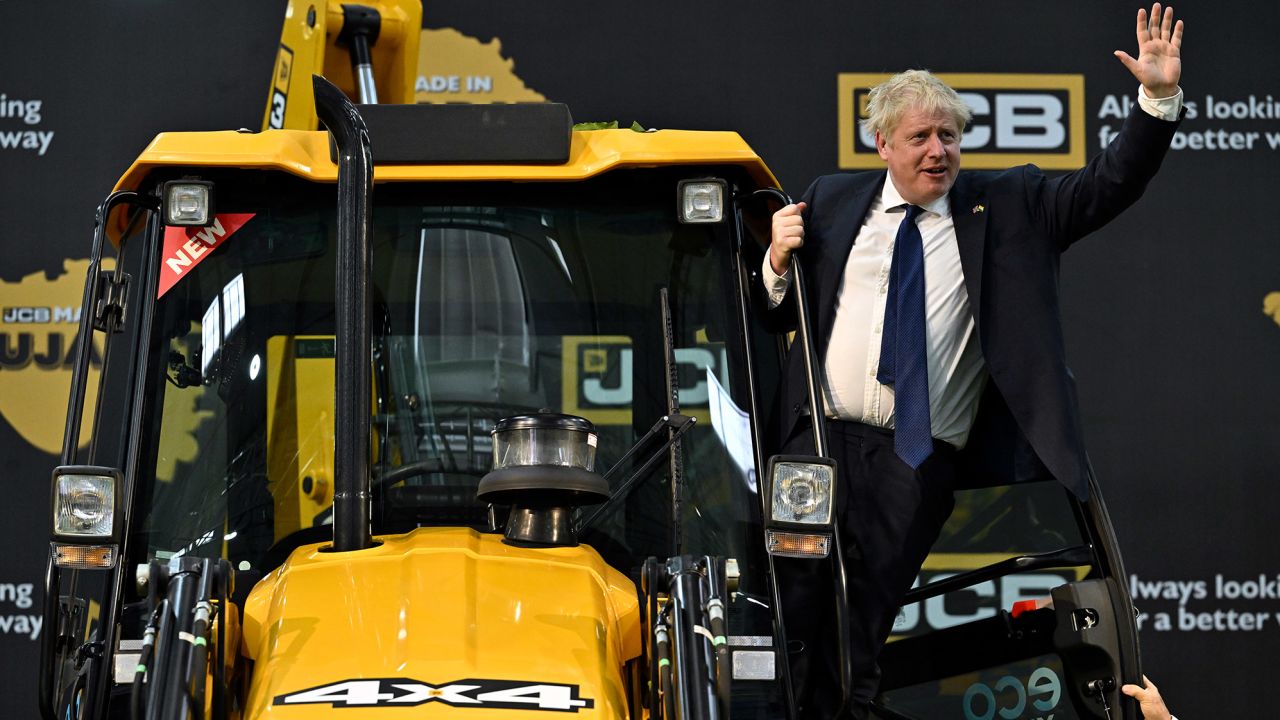 British Prime Minister Boris Johnson waves from a digger at a JCB factory in Gujarat, during his trip to India in April.