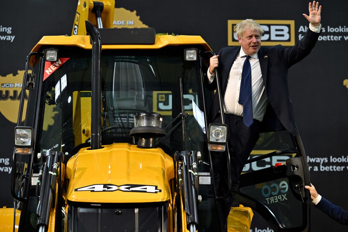 British Prime Minister Boris Johnson waves from a digger at a JCB factory in Gujarat, during his trip to India in April.