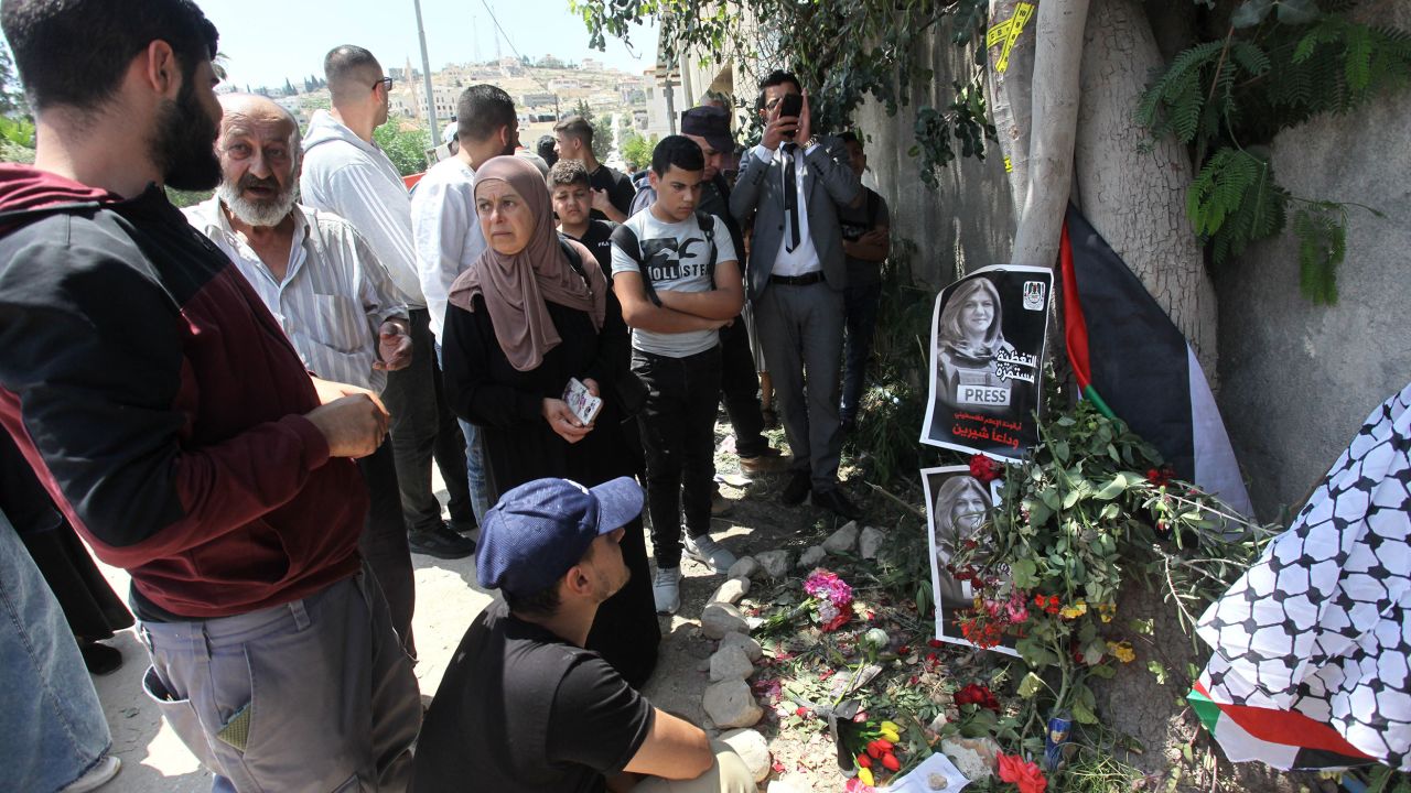 Palestinians place flowers at the place where Abu Akleh was killed in Jenin.