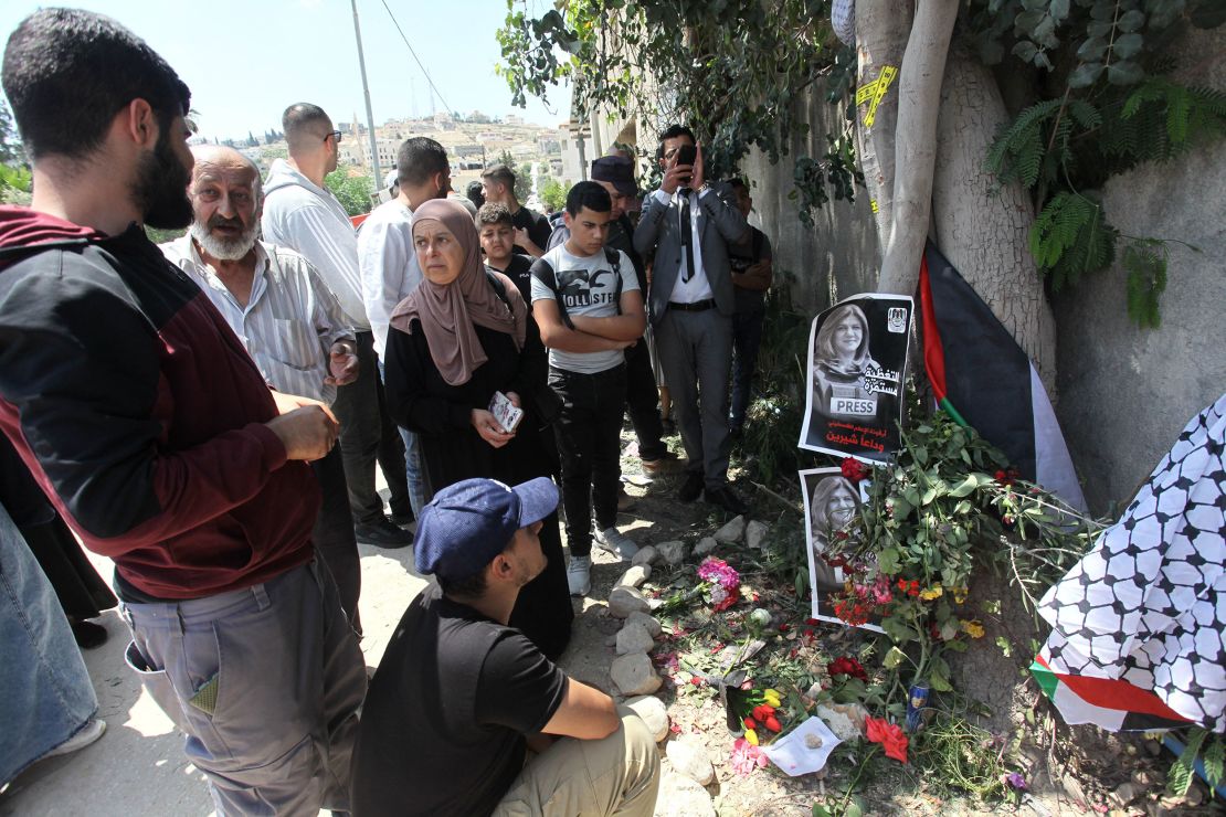 Palestinians place flowers at the place where Abu Akleh was killed in Jenin.