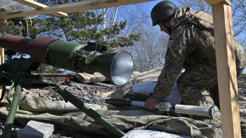 A Ukrainian soldier prepares a rocket launcher on the front line near Kyiv on March 20, 2022.
