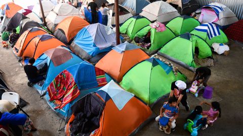Children play as families live in tents at a shelter in Tijuana, Mexico, which houses refugee migrants seeking asylum in the United States.