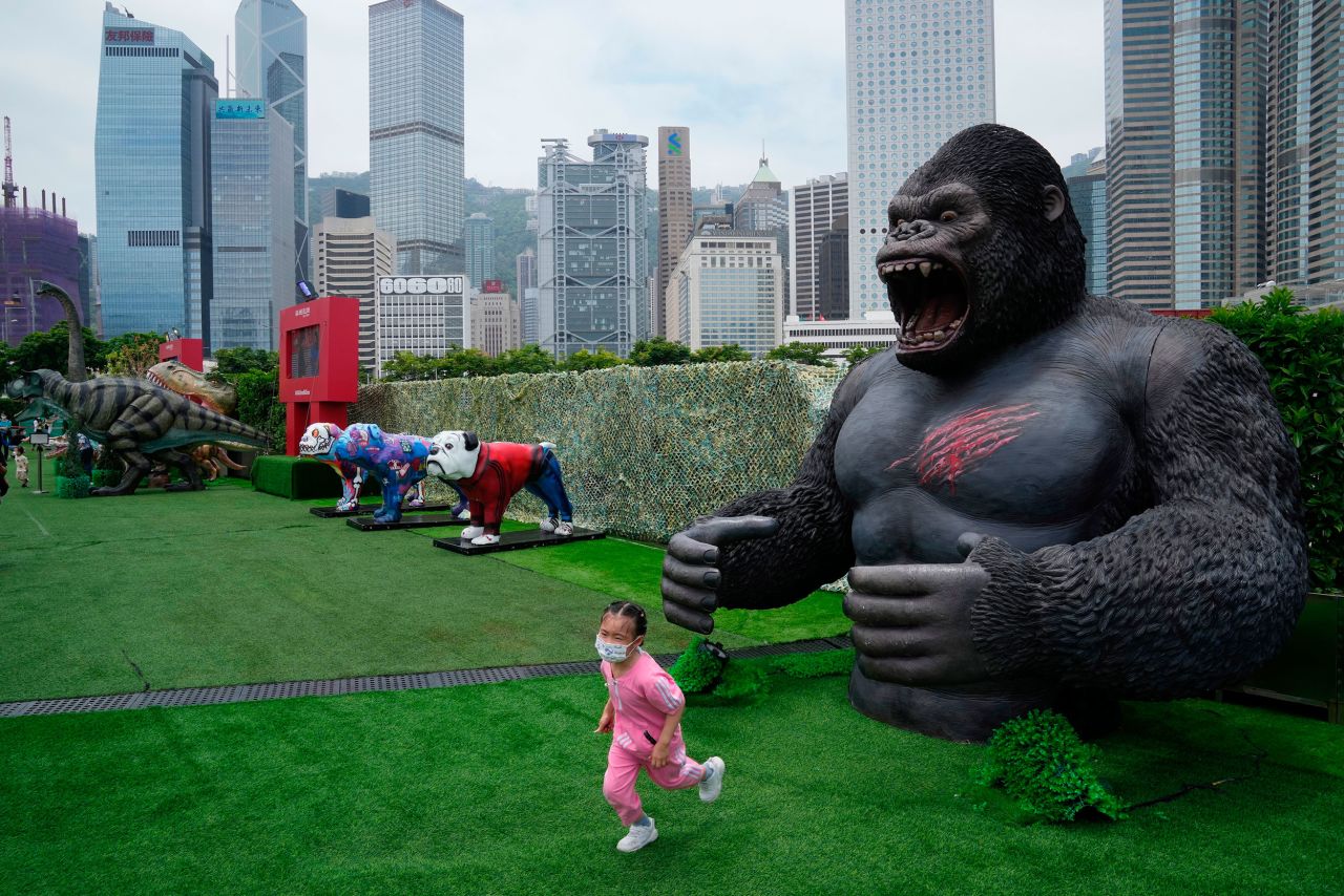 A girl runs away from a gorilla replica at a park in Hong Kong on Monday, May 9.