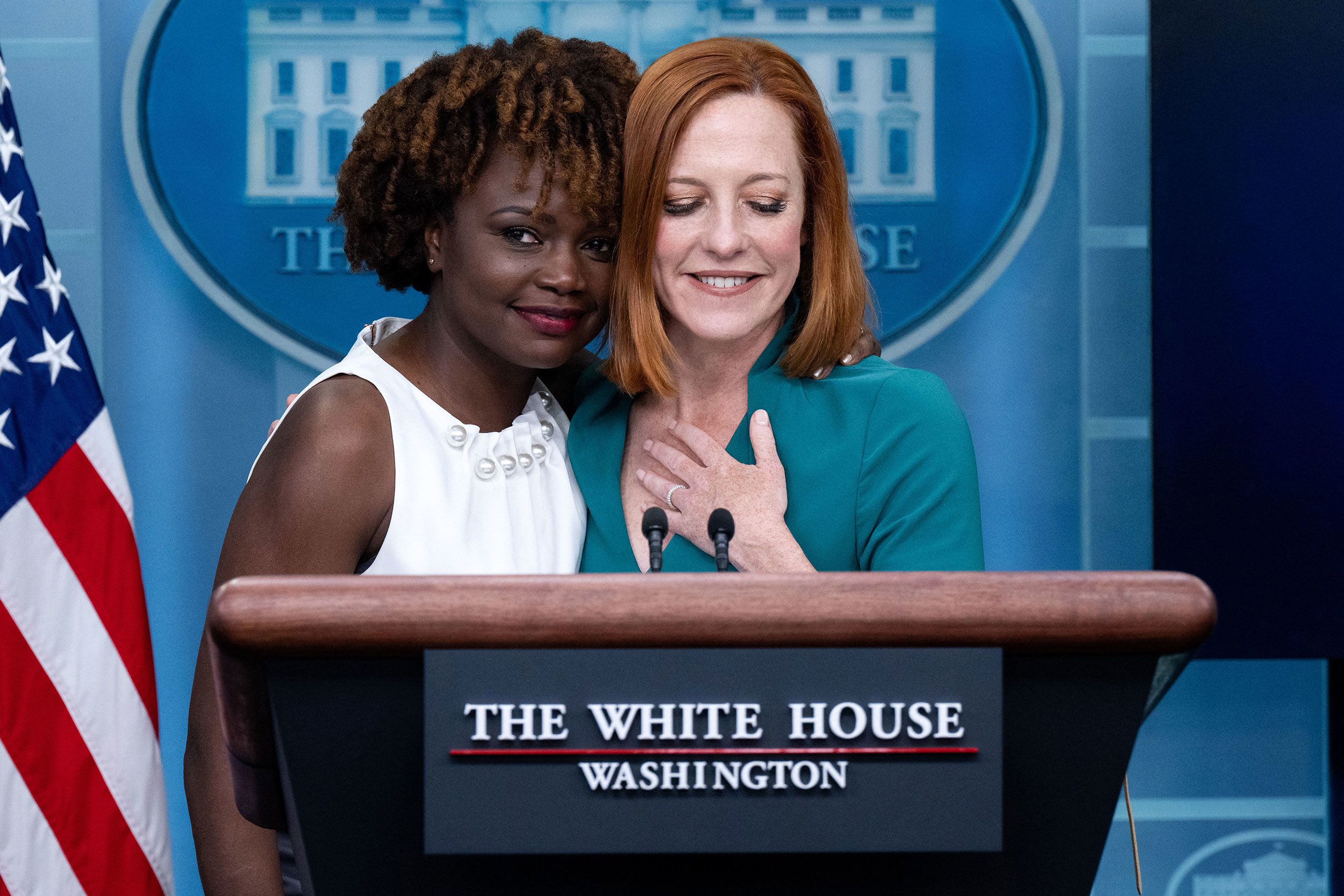 White House press secretary Jen Psaki, right, is hugged by Karine Jean-Pierre.