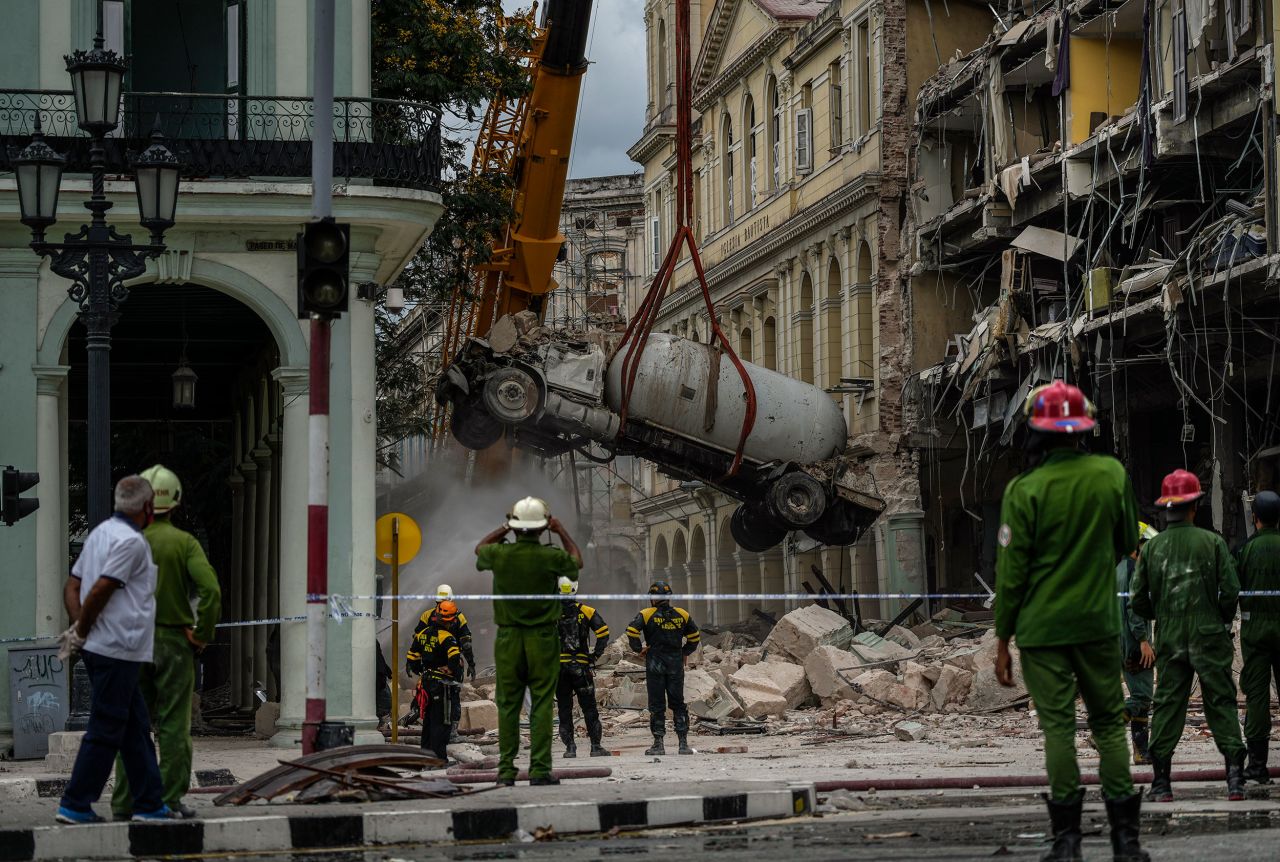 Firefighters spray a tanker truck with water to cool it down as it is removed from the site of an explosion <a href="https://www.cnn.com/2022/05/06/americas/hotel-saratoga-cuba-explosion/index.html" target="_blank">that destroyed the Hotel Saratoga</a> in Havana, Cuba, on Friday, May 6. A gas leak is thought to be the cause of <a href="http://www.cnn.com/2022/05/06/americas/gallery/cuba-hotel-explosion/index.html" target="_blank">the blast,</a> which killed at least 30 people.