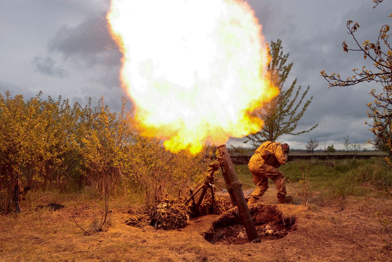 A Ukrainian serviceman fires a mortar in the country's Kharkiv region on Monday, May 9.