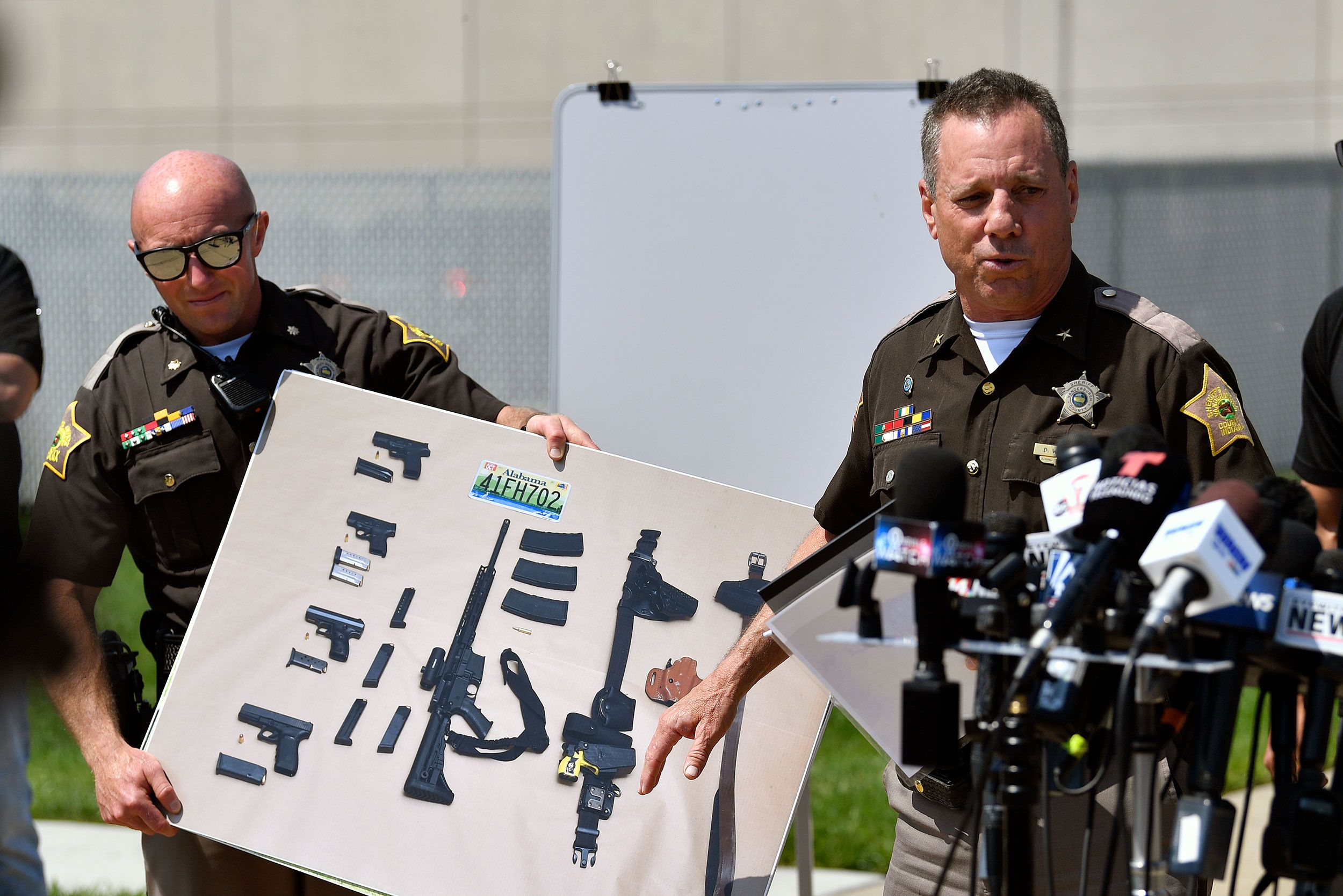 During a news conference in Evansville, Indiana, on Tuesday, May 10, Vanderburgh County Sheriff Dave Wedding shows a photo of weapons that he said were found in possession of fugitives Casey White and Vicky White.