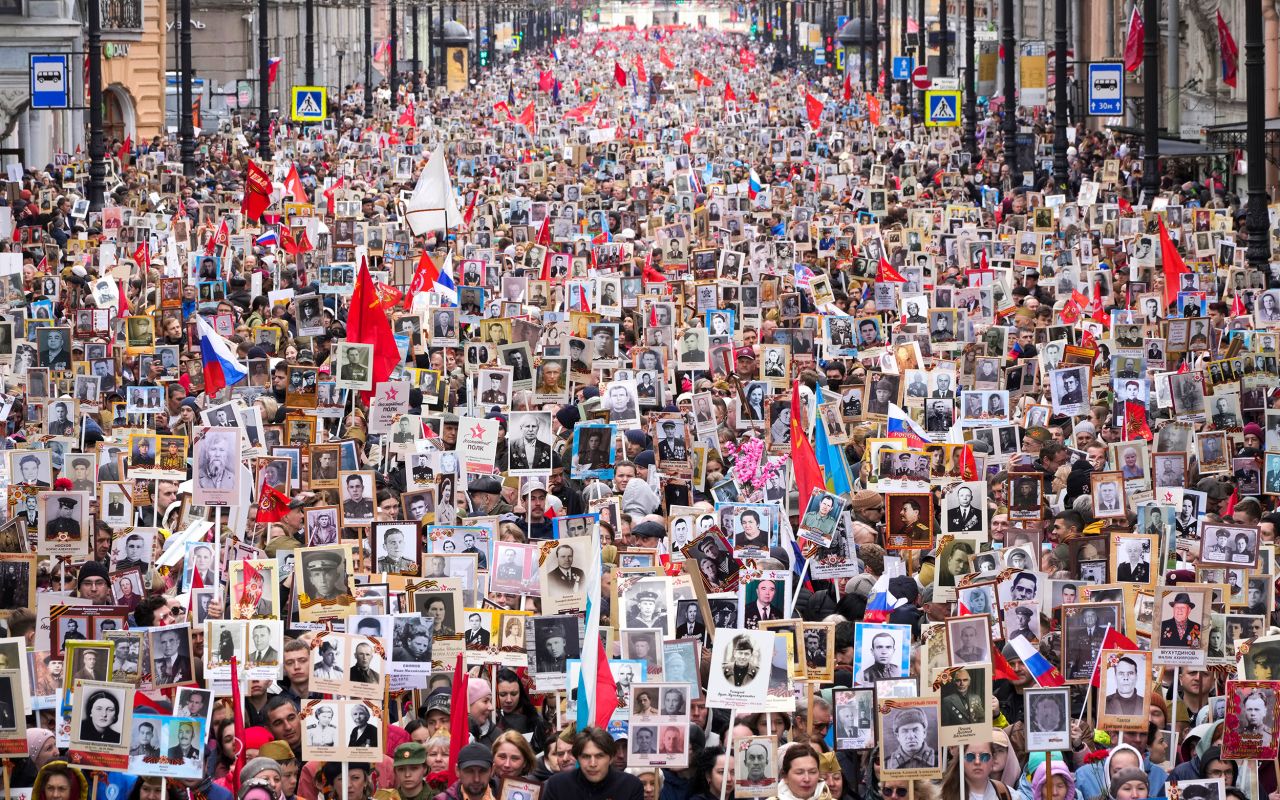 People in St. Petersburg, Russia, carry portraits of relatives who fought in World War II during the Immortal Regiment march on Monday, May 9. They were marking the 77th anniversary of the end of World War II.