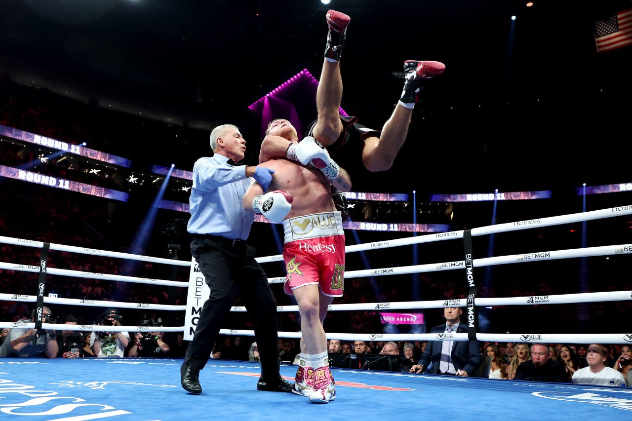 Canelo Alvarez picks up Dmitry Bivol during their light-heavyweight title fight in Las Vegas on Saturday, May 7. <a href="https://www.cnn.com/2022/05/08/sport/canelo-alvarez-dmitry-bivol-boxing-spt-intl/index.html" target="_blank">Bivol retained his title</a> by unanimous decision. It was just the second loss of Alvarez's career.