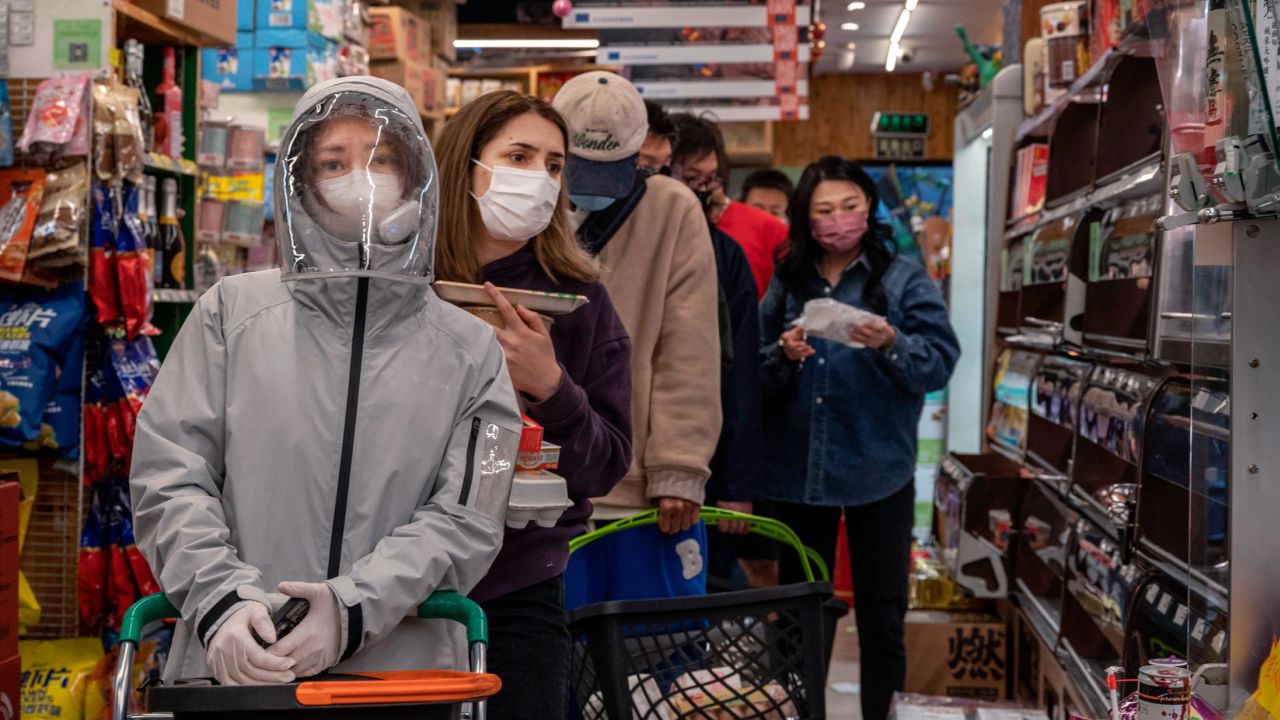 People wait in long lines at a supermarket on May 12 in Beijing, China.