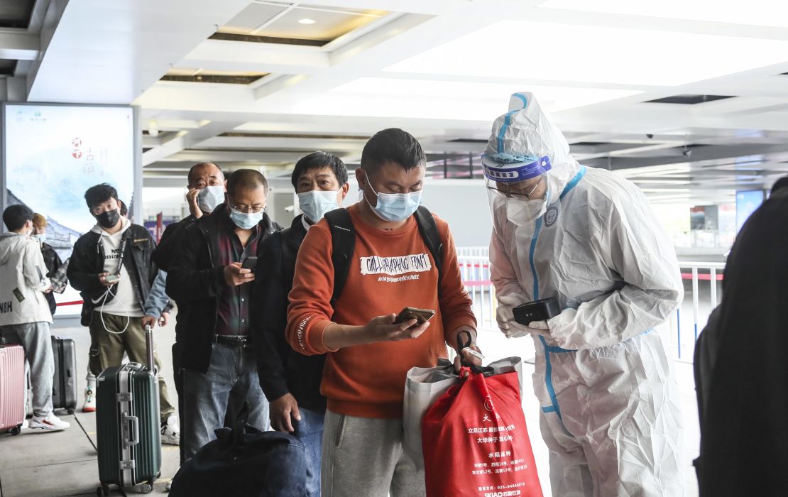 Covid workers check the travel information of passengers at a high-speed railway station in Huai 'an, China, on May 11.