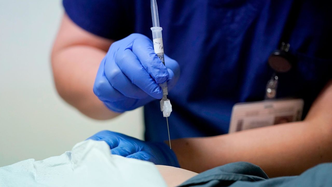 Ray Hoffman, who is immune-compromised, is given a shot of the two-shot dose of AstraZeneca's Evusheld — the first set of antibodies grown in a lab to prevent COVID-19, Thursday, Jan. 20, 2022, by Jose Lazaro, a medical assistant at a University of Washington Medicine clinic in Seattle. The two-shot dose is supposed to give patients like Hoffman, who can't make his own virus-fighters due to taking strong immune-suppressing drugs after liver and kidney transplants, some protection against COVID-19 for six months. (AP Photo/Ted S. Warren)