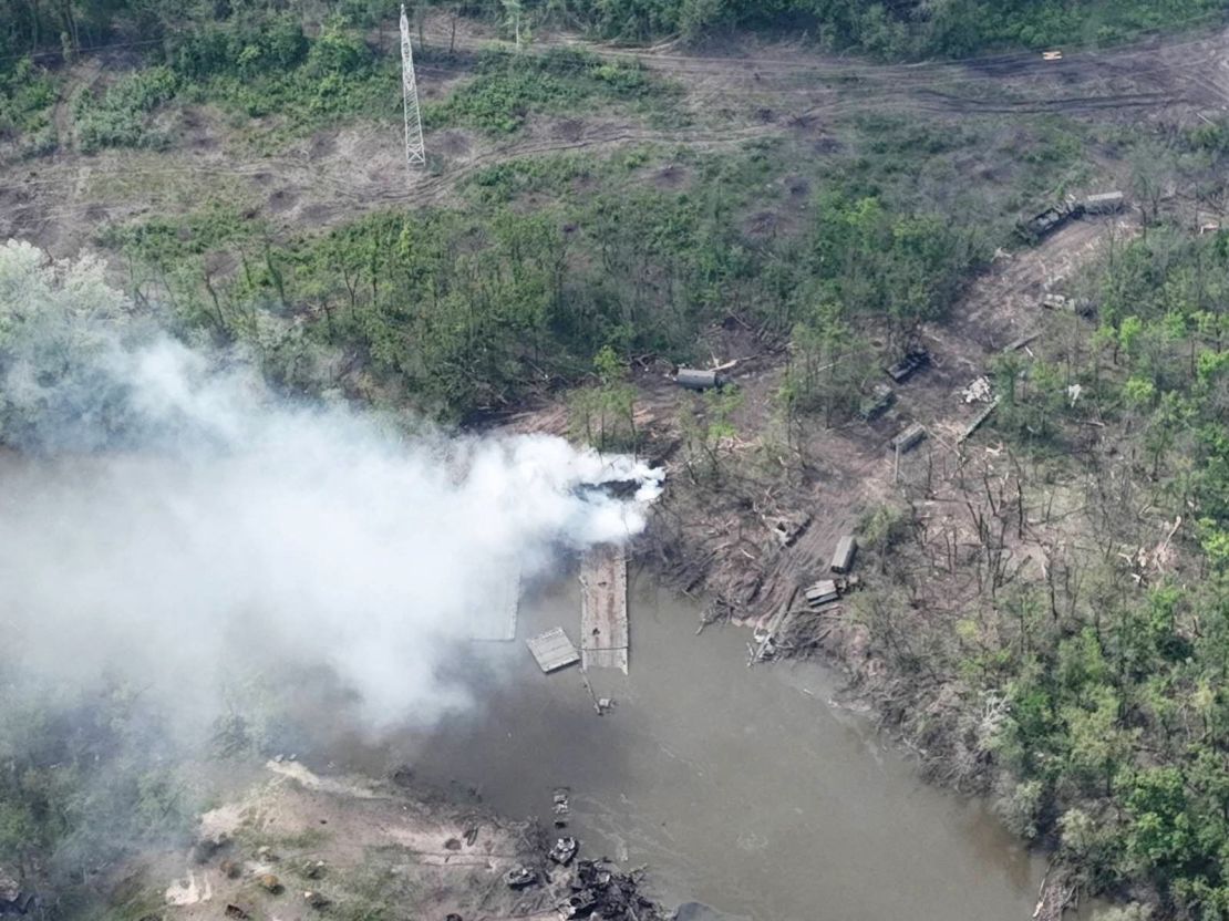 Smoke rises from what appears to be a makeshift bridge across the Siverskyi Donets River in a handout image from Ukrainian Airborne Forces Command, provided on May 12, 2022.