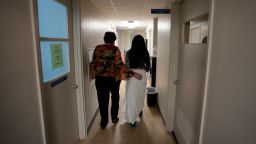 FILE - A 33-year-old mother of three from central Texas is escorted down the hall by clinic administrator Kathaleen Pittman prior to getting an abortion, Saturday, Oct. 9, 2021, at Hope Medical Group for Women in Shreveport, La. The woman was one of more than a dozen patients who arrived at the abortion clinic, mostly from Texas, where the nation's most restrictive abortion law remains in effect. (AP Photo/Rebecca Blackwell, File)