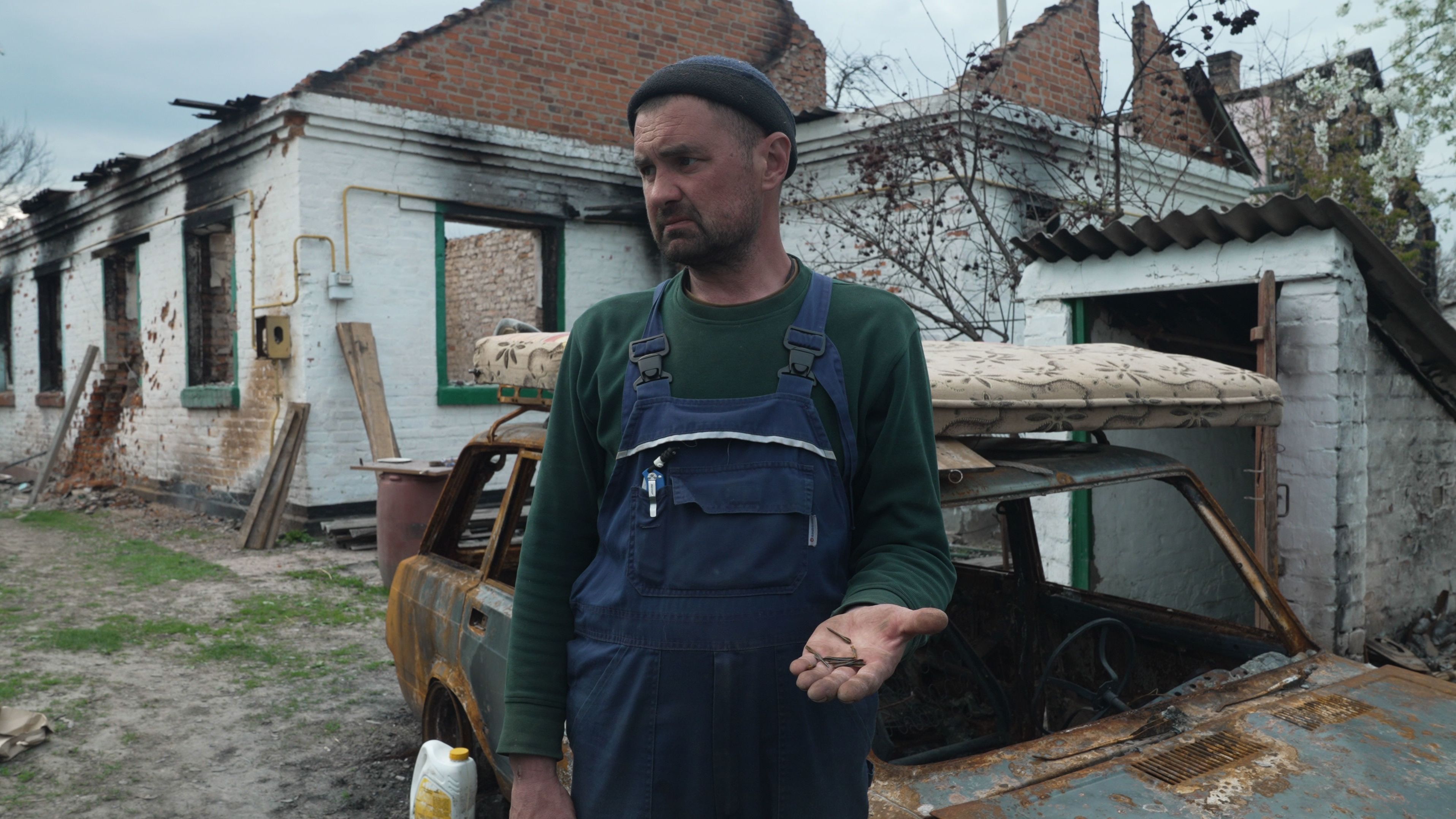 Vadim Bozhko holds the flechettes he found near his home in Andriivka.