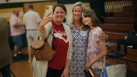 School board candidate and current board chair Deanna Kaplan, center, takes a selfie with supporters at West Forsyth High School on May 11.