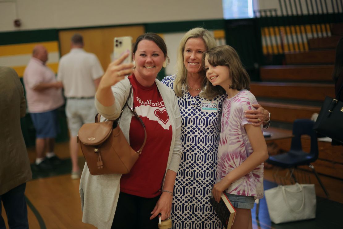 School board candidate and current board chair Deanna Kaplan, center, takes a selfie with supporters at West Forsyth High School on May 11.