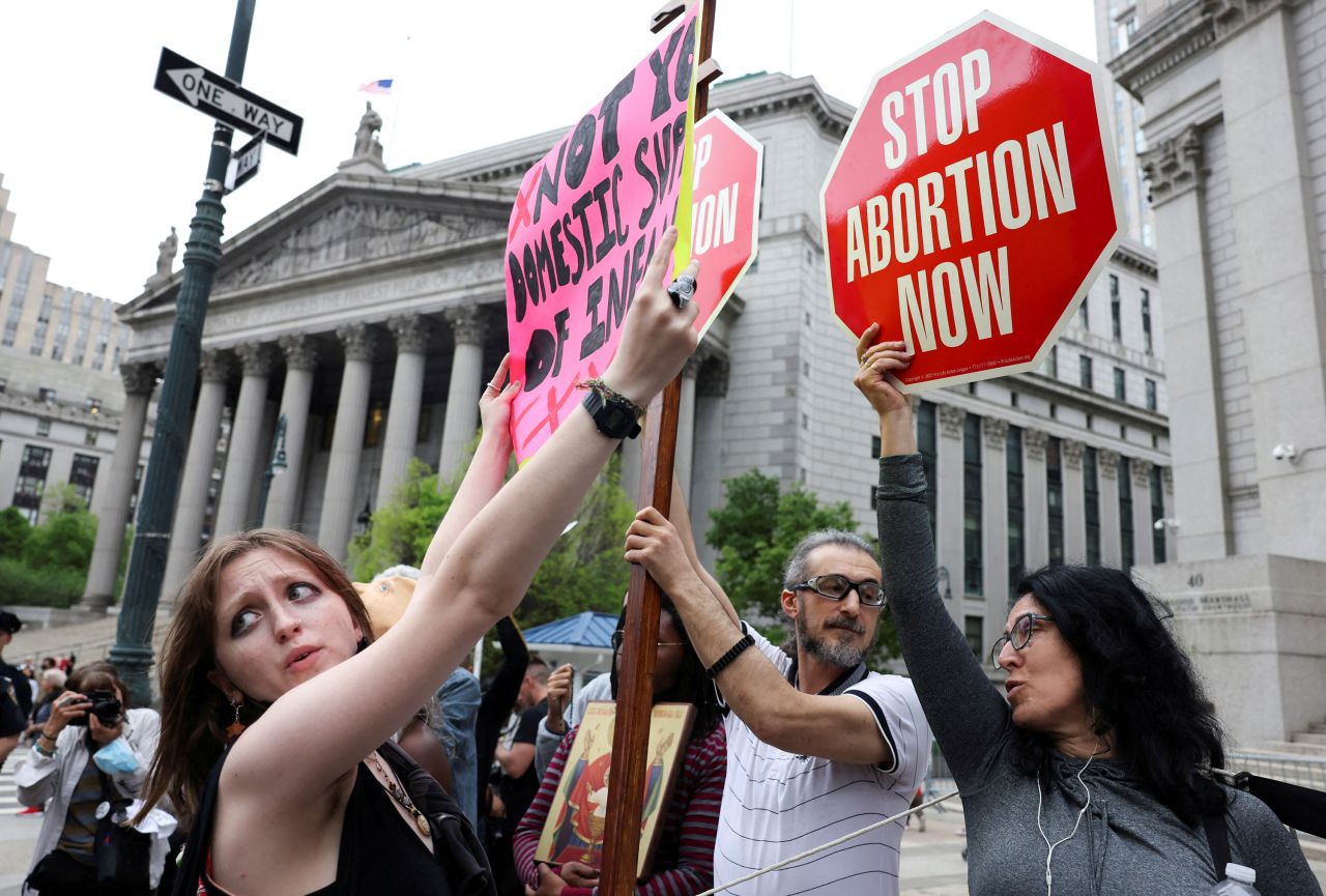 An abortion rights protester holds a placard in front of anti-abortion protesters during a demonstration in New York City.