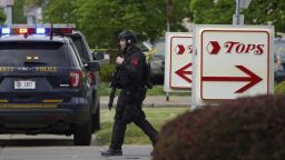 Police secure the area around a supermarket where several people were killed in a shooting, Saturday, May 14, 2022 in Buffalo, N.Y.