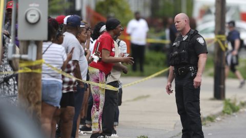 Police speak to bystanders after the shooting at a supermarket on May 14, 2022, in Buffalo, New York.