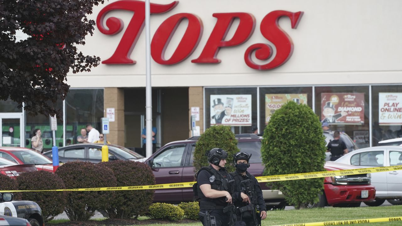 Police secure an area around a supermarket where several people were killed in a shooting, Saturday, May 14, 2022 in Buffalo, N.Y. Officials said the gunman entered the supermarket with a rifle and opened fire. Investigators believe the man may have been livestreaming the shooting and were looking into whether he had posted a manifesto online (Derek Gee/The Buffalo News via AP)