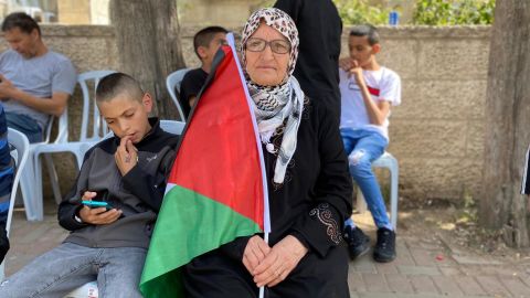 Nafisa Khwais, 63, sits outside Shireen Abu Akleh's home in Ramallah, where mourners have gathered. 