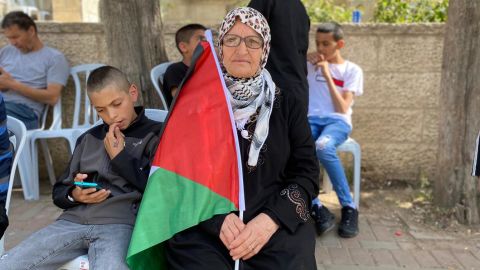 Nafisa Khwais, 63, sits outside Shireen Abu Akleh's home in Ramallah where mourners have gathered.