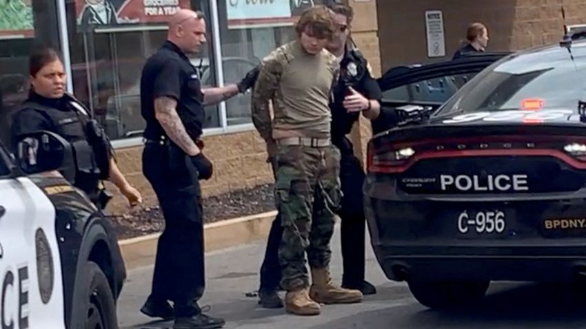 A man is detained following a mass shooting in the parking lot of TOPS supermarket, in a still image from a social media video in Buffalo, New York, U.S. May 14, 2022.  Courtesy of BigDawg/ via REUTERS THIS IMAGE HAS BEEN SUPPLIED BY A THIRD PARTY. MANDATORY CREDIT