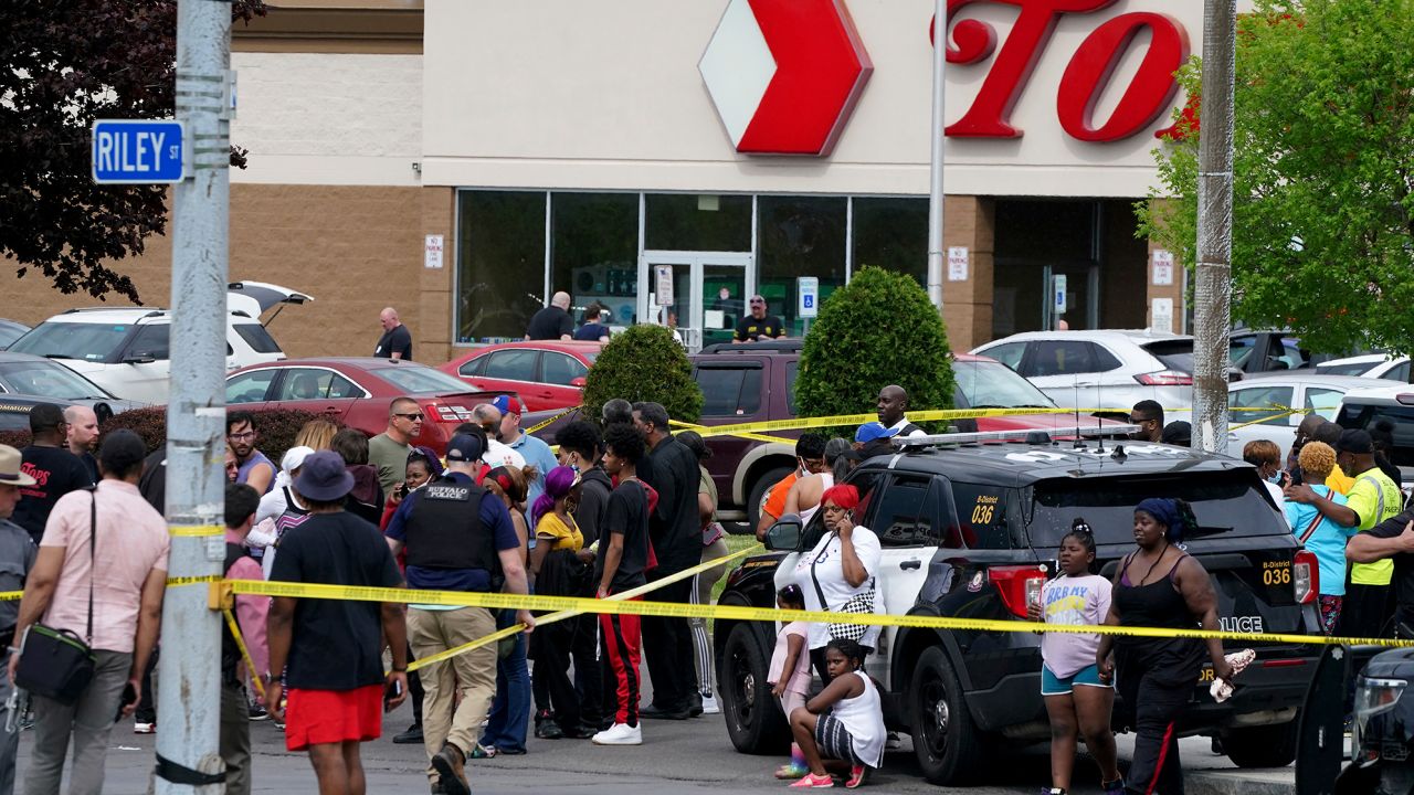 People gather outside a supermarket in Buffalo, New York, where 10 people were killed on Saturday.