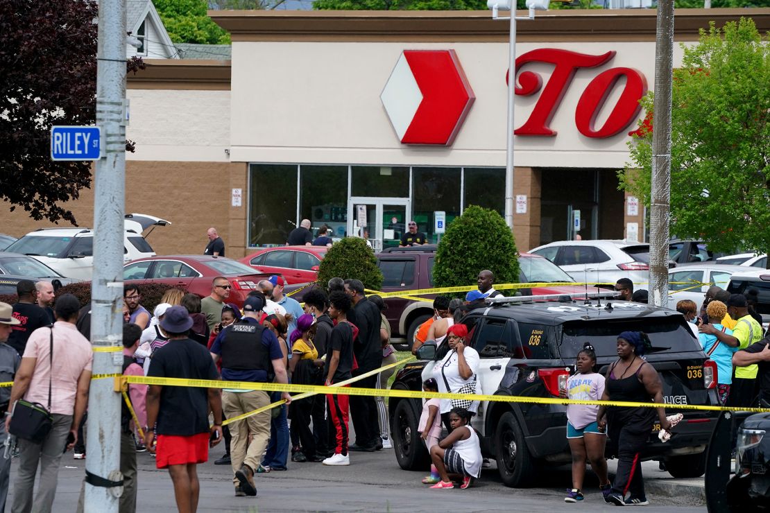 People gather outside a supermarket in Buffalo, New York, where 10 people were killed on Saturday.