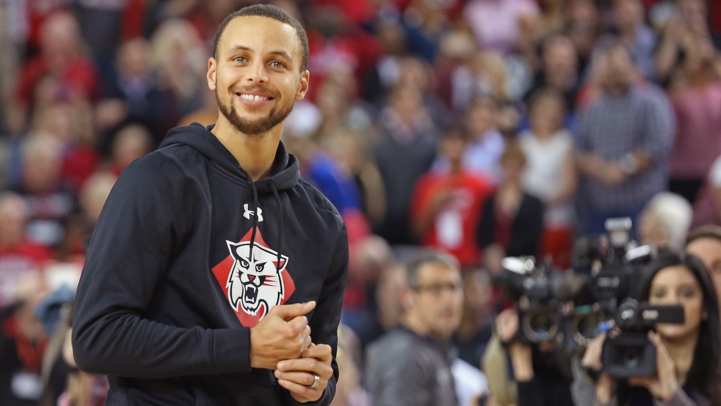 Steph Curry smiles on the court during a ceremony to name the student section at Davidson College's John M. Belk Area after him, on January 24, 2017.