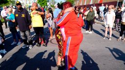 People embrace outside the scene of a shooting at a supermarket, in Buffalo, N.Y., Sunday, May 15, 2022. 