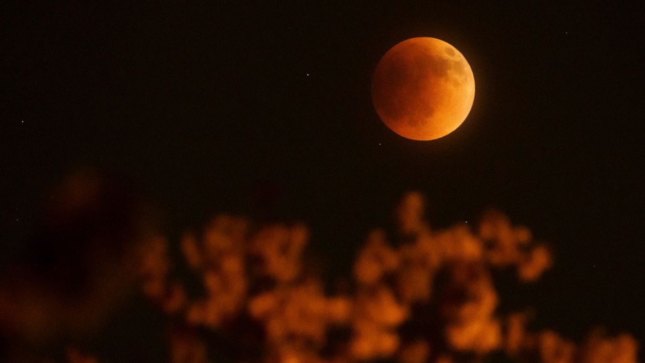 The moon glows red over Columbus, Ohio on Sunday.
