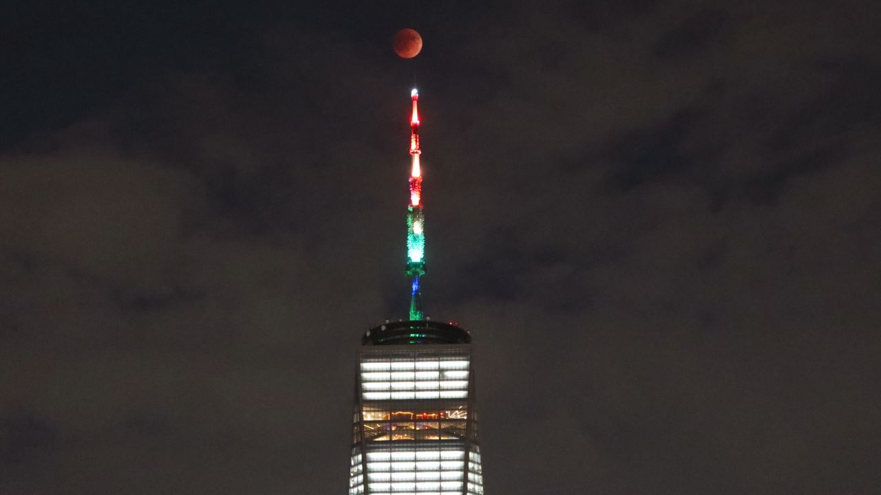 The blood moon rises over lower Manhattan and One World Trade Center in New York City on May 15, 2022. 
